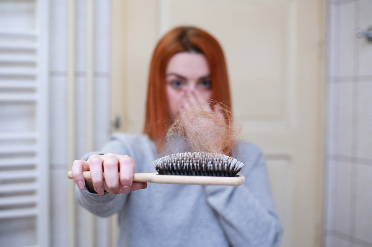 Woman holding a brush with hair